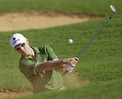 Ben Crane hits out of a bunker at the Tournament of Champions, considered the “opener” of the PGA season. (Associated Press)