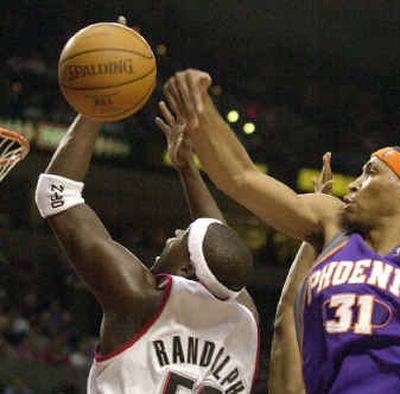 
Phoenix forward Shawn Marion, right, comes in from behind to block a shot by Portland forward Zach Randolph.
 (Associated Press / The Spokesman-Review)