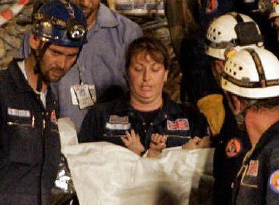 
A woman of the British RAPID UK search-and-rescue team carries a 2-year-old boy after he was rescued on Monday from the rubble of a collapsed building in Islamabad, Pakistan. 
 (Associated Press / The Spokesman-Review)