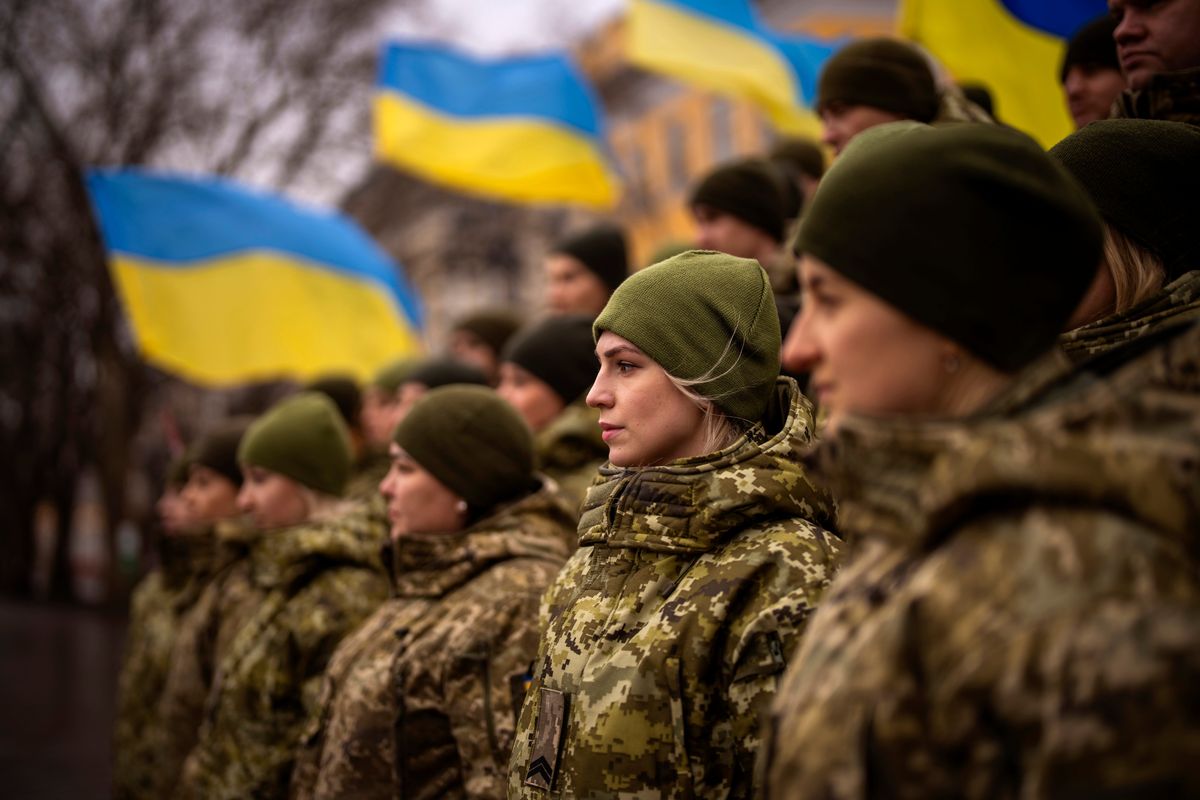 Ukrainian Army soldiers pose for a photo as they gather to celebrate a Day of Unity on Wednesday in Odessa, Ukraine. The Ukrainian President Zelenskyy called for the day, on which Ukrainian flags were raised across the country.  (Emilio Morenatti)