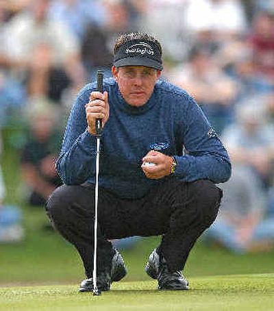 
Phil Mickelson comtemplates his final putt of the day on the ninth green.
 (Associated Press / The Spokesman-Review)