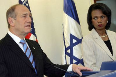 
U.S. Secretary of State Condoleezza Rice, right, listens as Israeli Prime Minister Ehud Olmert makes a statement to the media before their meeting in Jerusalem on Tuesday.
 (Associated Press / The Spokesman-Review)