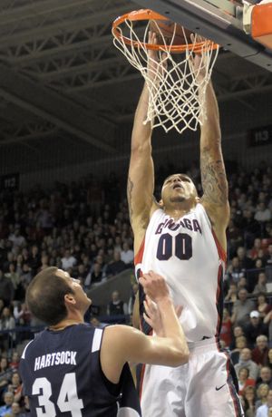 BYU’s Noah Hartsock watches as Gonzaga's Robert Sacre takes the ball to the basket. Sacre finished with eight points. (Associated Press)