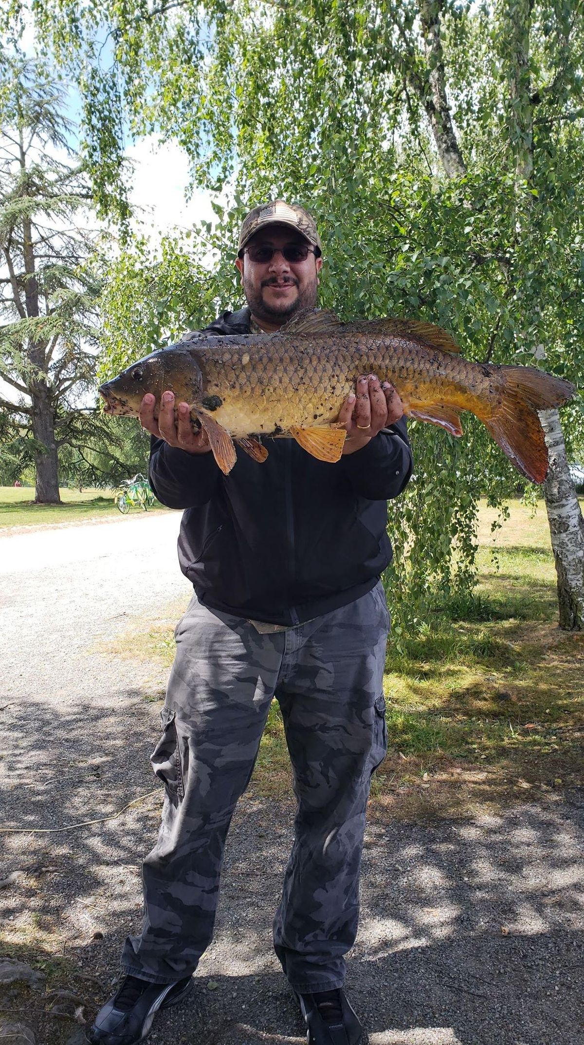 Ahmed Majeed shows off his catch of a huge carp on Saturday, June 9 at Green Lake. (Courtesy of / Ahmed Majeed)