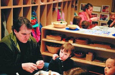 
Chris DeForest and his son John,  4, eat lunch together at the Community Building's on-site daycare center.  
 (Jed Conklin / The Spokesman-Review)