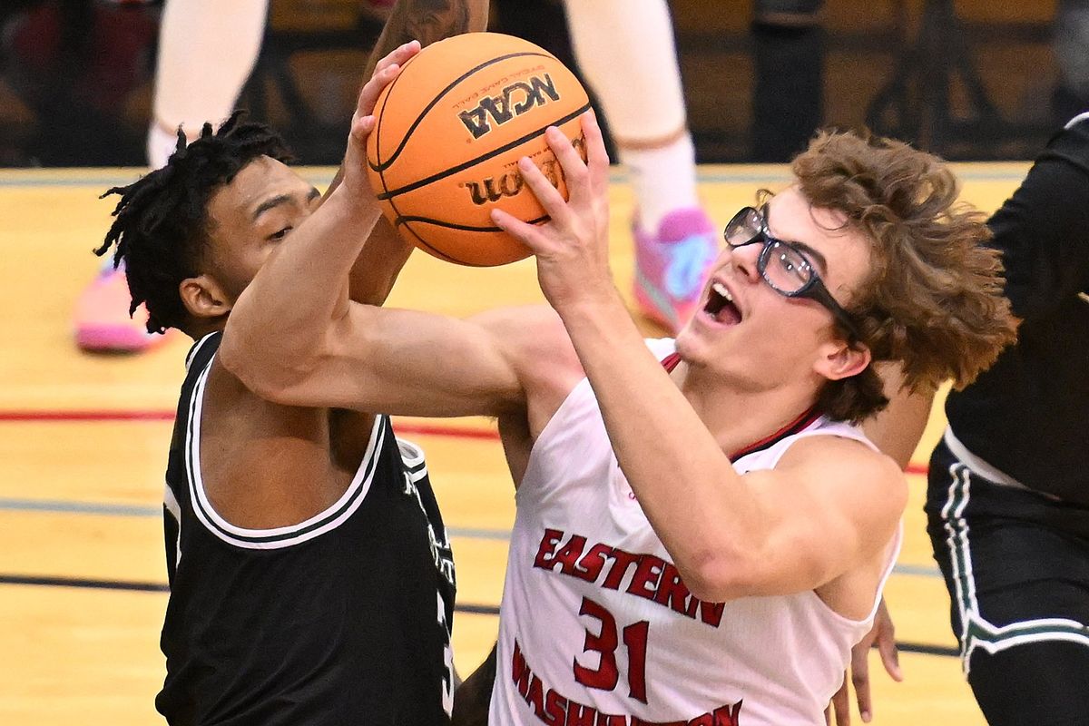 Eastern Washington Eagles forward Casey Jones (31) puts up a shot against Portland State Vikings forward KJ Allen (3) in first half at Reese Court on Thurs. Dec.28, 2023 in Cheney WA.  (James Snook)