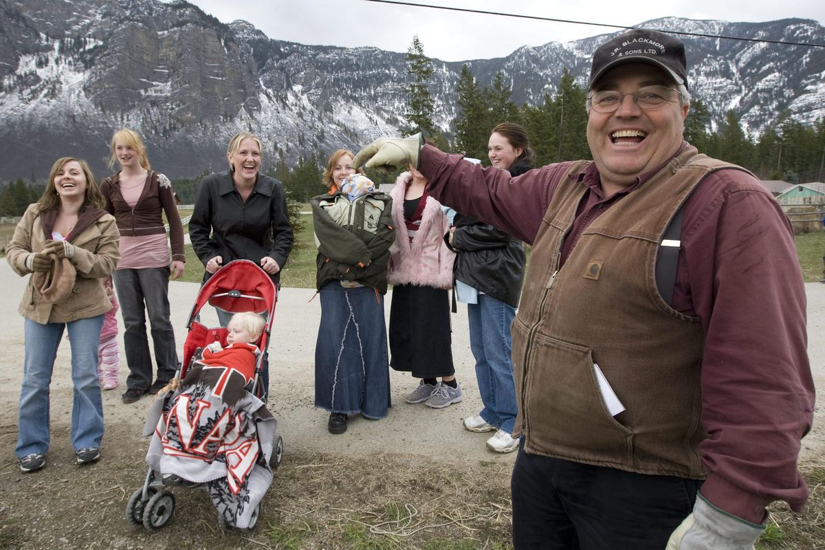 In this April 21, 2008, file photo, Winston Blackmore, the religious leader of the controversial polygamous community of Bountiful located near Creston, British Columbia, shares a laugh with six of his daughters and some of his grandchildren. (Jonathan Hayward / Canadian Press)