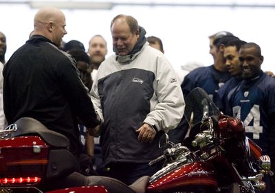 Associated Press Mike Holmgren, center, shakes hands with offensive lineman Mike Wahle after the coach was presented with a Harley-Davidson motorcycle. (Associated Press / The Spokesman-Review)