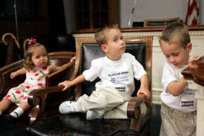 
Frozen embryo adoptees, from left, Ella Gray, 19 months, of Phoenix, and twins Ben and Sam Hutchens, 3, of Dallas, take part in a stem cell news briefing on Tuesday. 
 (Associated Press / The Spokesman-Review)