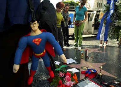 Fans gather around Christopher Reeve's Hollywood Walk of Fame star Monday in the Hollywood section of Los Angeles, to pay tribute to the actor whose career soared in four
