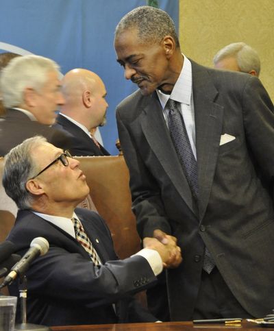 Gov. Jay Inslee congratulates WSU President Elson Floyd after signing a bill that gives WSU authority to start its own medical school in Spokane. (Jim Camden)