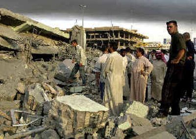 
Local residents search through the rubble of a destroyed building in the center of Fallujah early Tuesday following a U.S. airstrike. 
 (Associated Press / The Spokesman-Review)