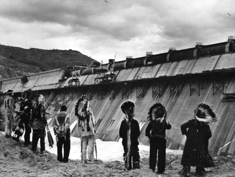 This is a picture taken by William S. Russell for the Bureau of Reclamation in 1941 of the traditional Chiefs of the Colville Indian Reservation. This is some of the final steps to completing the Grand Coulee Dam. These chiefs gathered before this structure to witness the finishing of the dam. The photo is held at the Confederated Tribes of the Colville Reservation History and Archeology Program. It is also held at the WSU and University of Washington photo archives.