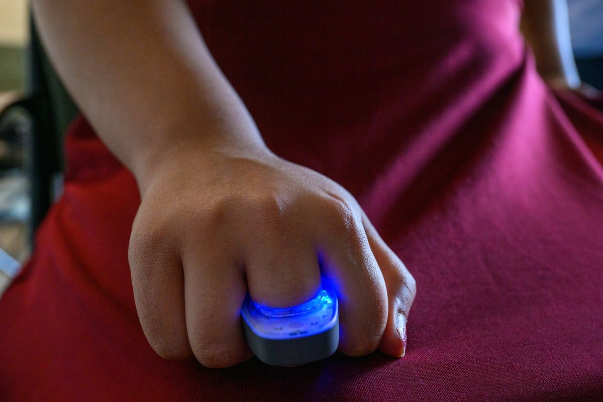 ***PHOTO ILLUSTRATION*** Sita Ganugapati, a Masters Degree student in the Edward R. Murrow College of Communication at Washington State University, poses to show how the sensor rings used in the study look while being used, Tuesday, Sept. 10, 2024, at Goertzen Hall in Pullman, Wash. The blue light just means the ring is activated. The rings detect sweat gland activity, an involuntary nervous system reaction activated by the psychological ‘fight or flight’ response test subjects emit while watching the Presidential Debate between Donald Trump and Kamala Harris.  (Dean Hare/WSU, PHOTO ILLUSTRATION)