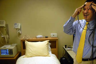 
Researcher Hans Van Dongen explains how sensors are attached to a patient to measure brain activity during sleep studies. 
 (Jed Conklin / The Spokesman-Review)