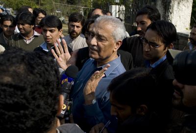Pakistani nuclear scientist Abdul Qadeer Khan, center, talks to media outside his home in Islamabad, Pakistan, on Friday.  (Associated Press / The Spokesman-Review)
