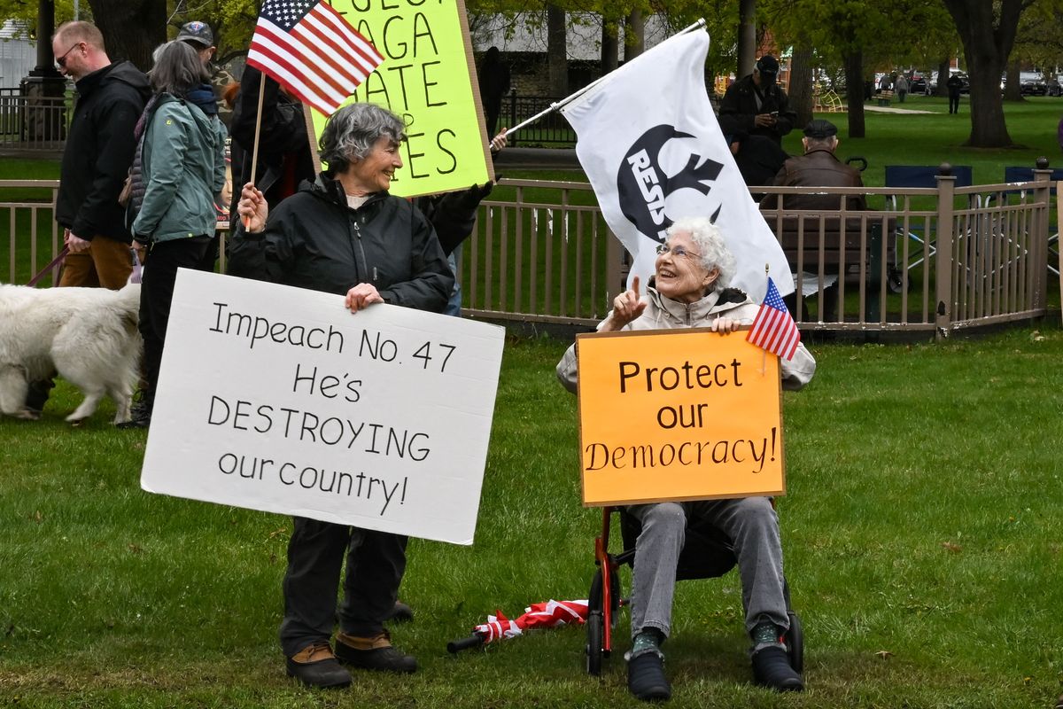 Lorna Emerich, 67, left, smiles at her mother Ann Widner, 89, as they protest during a Rally for Science protesting the policies of Pres. Donald Trump held by Spokane Indivisible on Saturday, Apr. 19, 2025, at Mission Park in Spokane, Wash.  (Tyler Tjomsland/The Spokesman-Review)