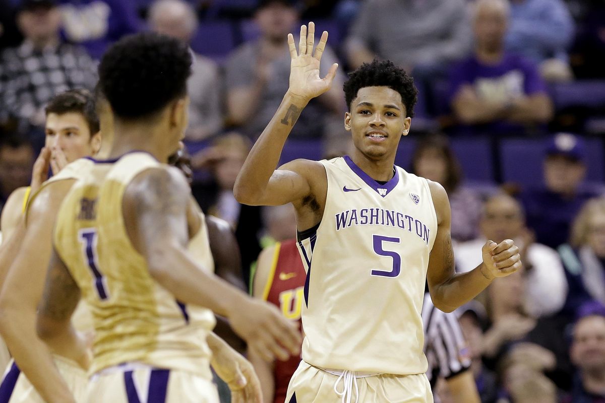 Washington’s Dejounte Murray is congratulated after scoring against USC during the second half on Sunday.