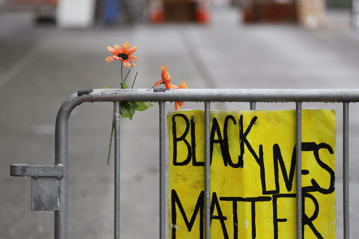 A barricade stands at the end of a street where a plywood-covered and closed Seattle police precinct stands Tuesday, June 9, 2020, in Seattle, following protests over the death of George Floyd, a black man who was in police custody in Minneapolis. Under pressure from city councilors, protesters and dozens of other elected leaders who have demanded that officers dial back their tactics, the police department on Monday removed barricades near its East Precinct building in the Capitol Hill neighborhood, where protesters and riot squads had faced off nightly. Protesters were allowed to march and demonstrate in front of the building, and the night remained peaceful.  (Elaine Thompson)