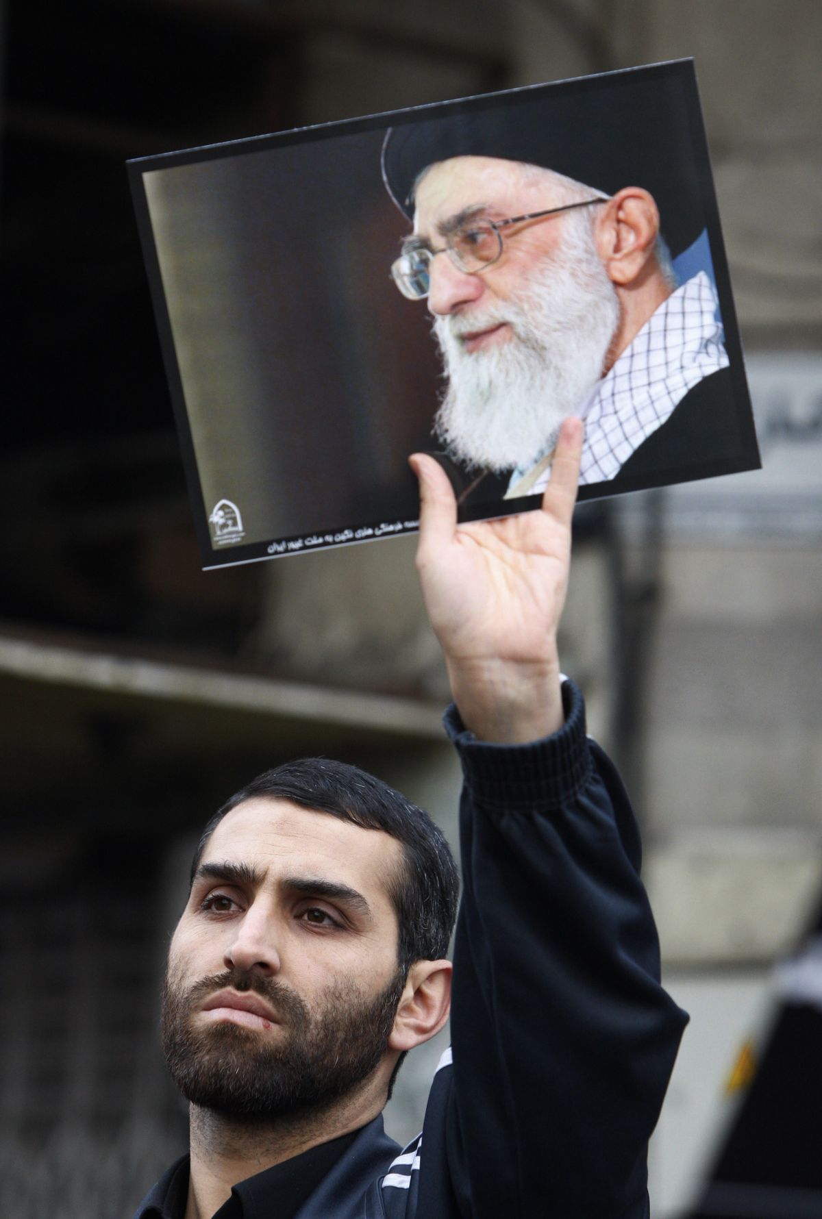 A demonstrator holds a poster of supreme leader Ayatollah Ali Khamenei at a Wednesday rally in Tehran.