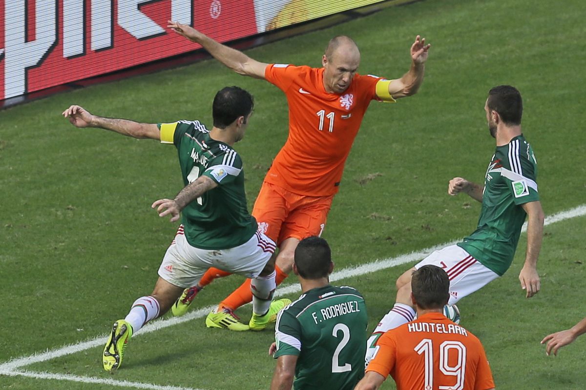 Mexico’s Rafael Marquez, left, fouls Netherlands’ Arjen Robben inside the penalty box, which led to winning shot by the Dutch. (Associated Press)