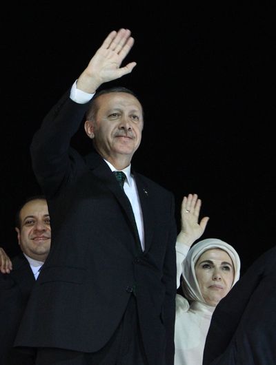 Turkish Prime Minister Recep Tayyip Erdogan and his wife, Emine, wave to the crowd upon their arrival at the Ataturk Airport near Istanbul today. (Associated Press)