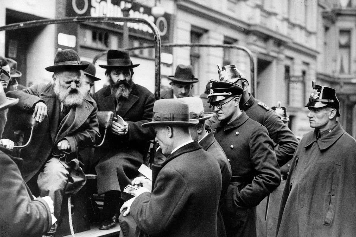 A busload of arrested Jewish men are questioned by government officials before being taken away in Berlin on April 11, 1933, shortly after Adolf Hitler