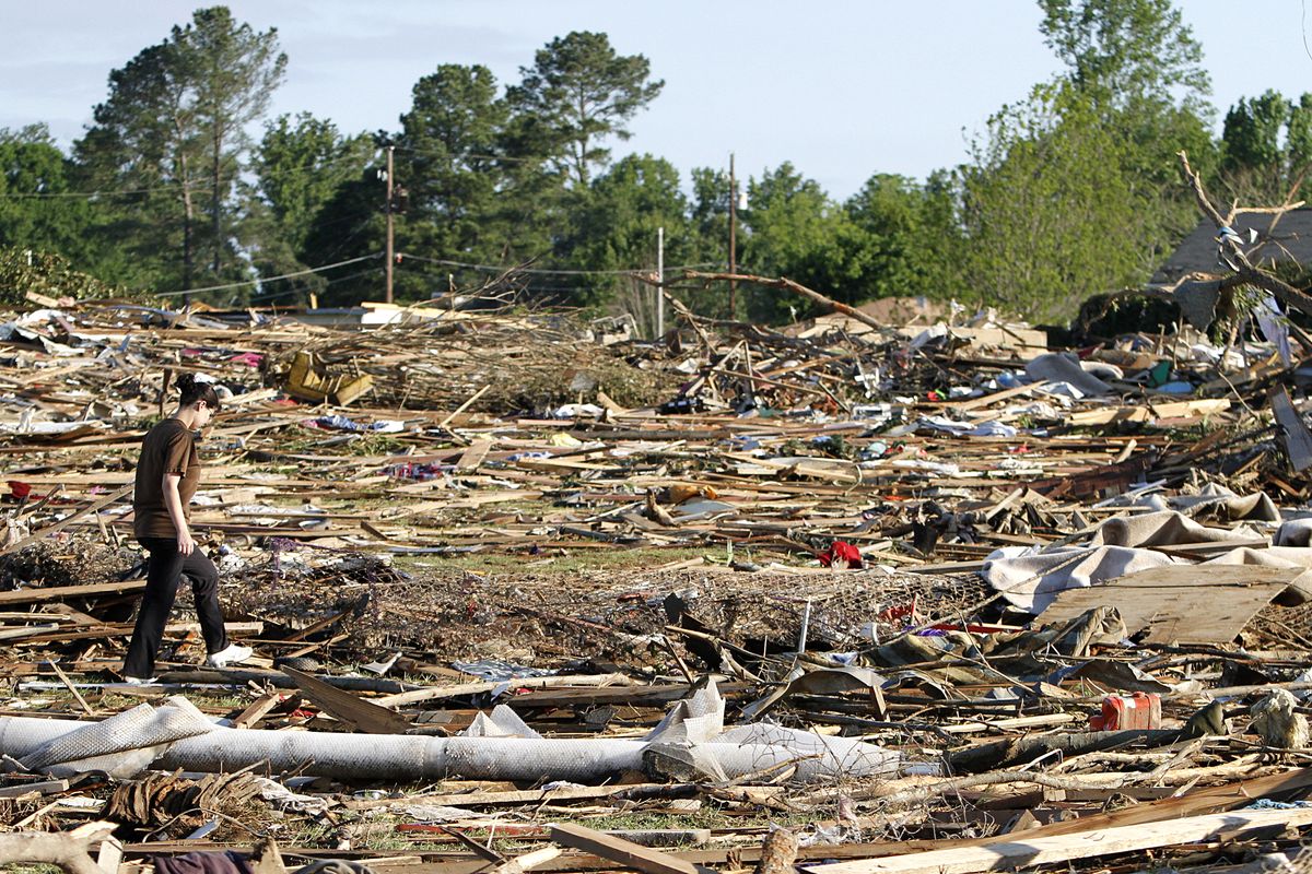 Tiffany Wood walks through her backyard looking for belongings Thursday, April 28, 2011 after a tornado hit Pleasant Grove just west of downtown Birmingham, Ala., Wednesday afternoon. (Butch Dill / Associated Press)