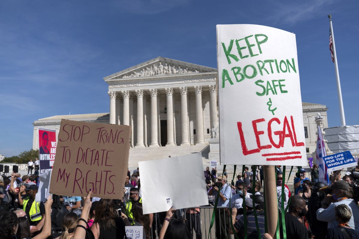 Demonstrators march outside of the the U.S. Supreme Court during the Women