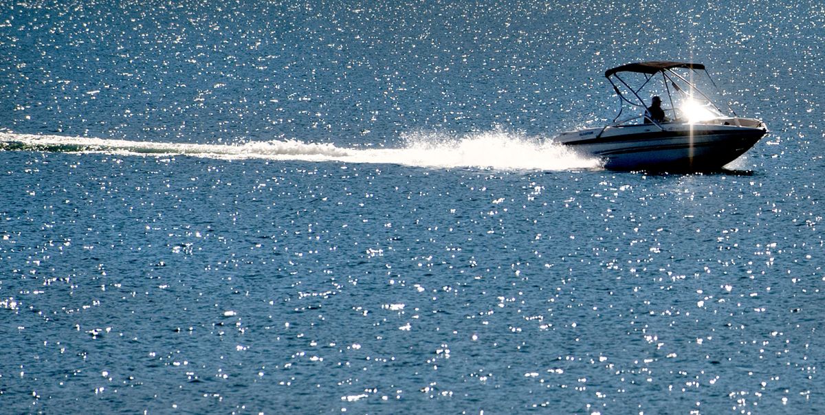 A boat cuts through Lake Pend Oreille in Sandpoint, Idaho, on Monday. Locals want the lake levels kept high through September for boating, but there are competing downstream interests. (Kathy Plonka)
