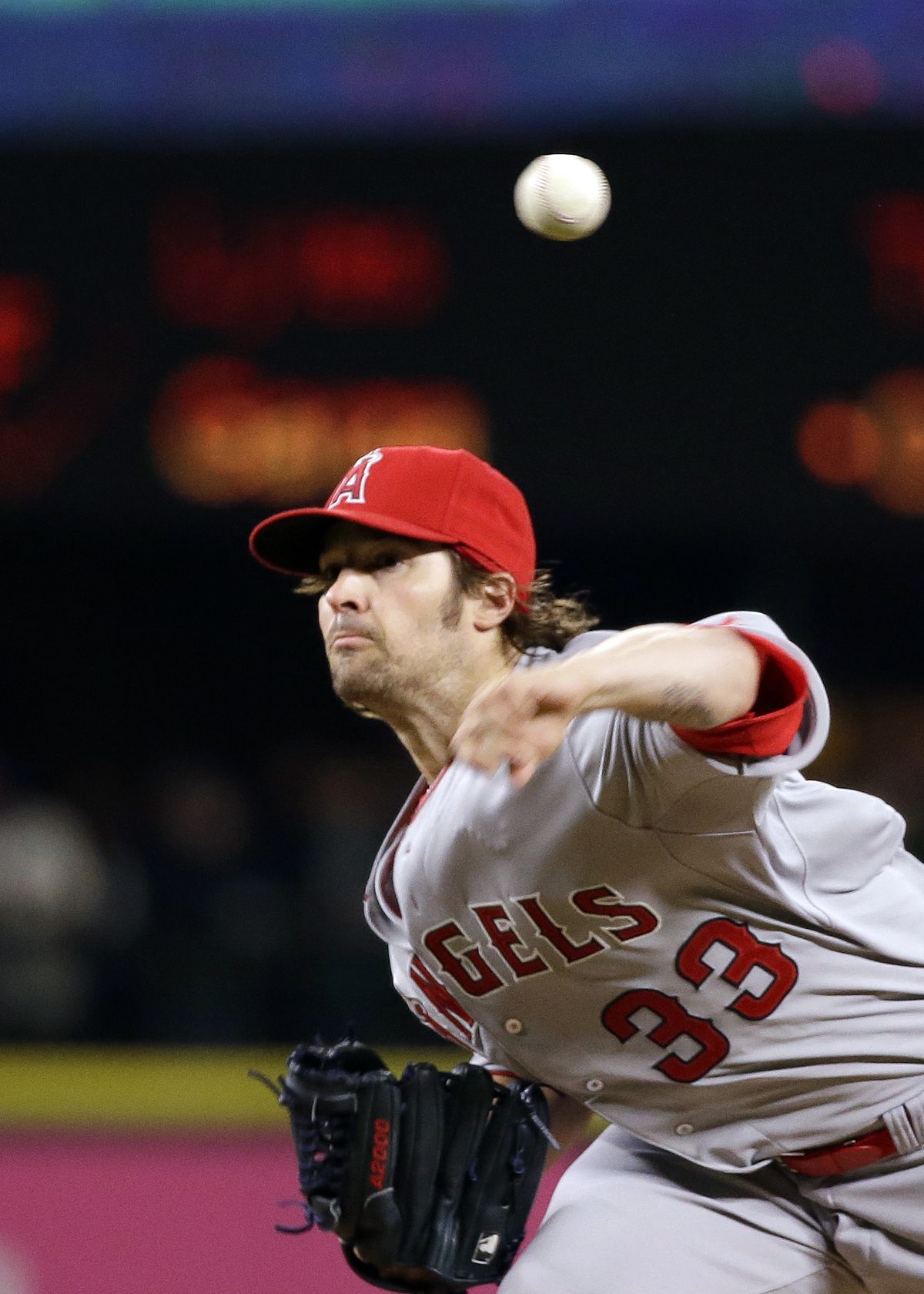 Angels starting pitcher C.J. Wilson held Mariners to two singles in 8 innings. (Associated Press)