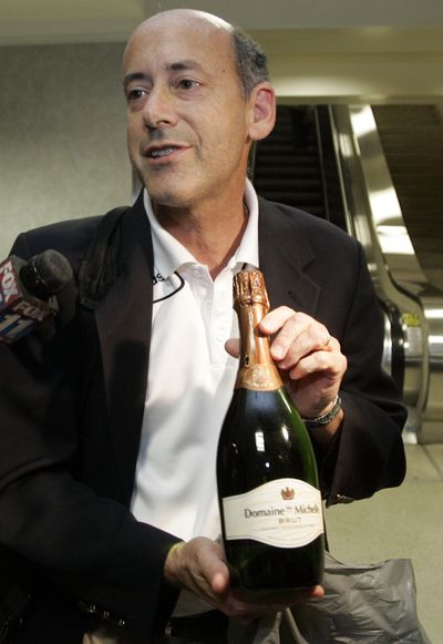 Craig Tornberg shows a bottle of champagne, a gift from a flight attendant, as he describes the scene aboard the flight.Associated Press (Associated Press / The Spokesman-Review)