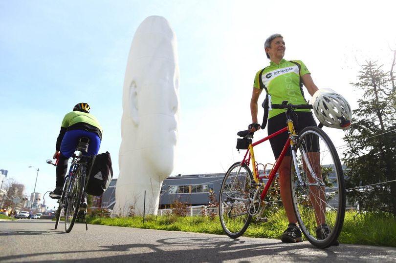 Catherine Hennings, right, board president of Cascade Bicycle Club, pauses on the bicycle trail at Seattle’s Myrtle Edwards Park, part of an urban loop she recommends. (John Lok/The Seattle Times / Associated Press)