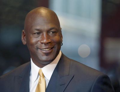 FILE - In this Aug. 21, 2015, file photo, former NBA star and current owner of the Charlotte Hornets, Michael Jordan, smiles at reporters in Chicago. Jordan is donating $7 million to at-risk communities in Charlotte to launch two medical clinics in troubled areas of the city. (Charles Rex Arbogast / Associated Press)