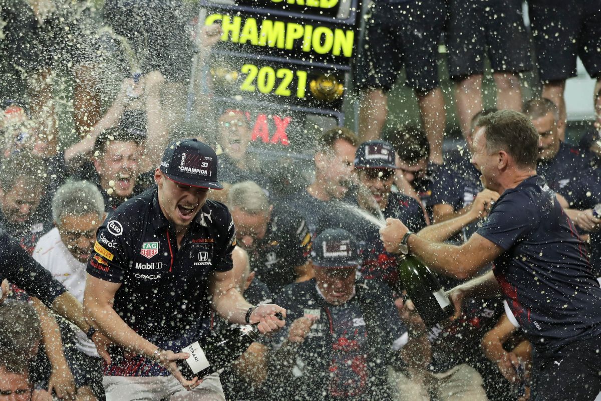 Red Bull driver Max Verstappen, left, celebrates with Red Bull team chief Christian Horner, right, and his team after winning the Formula One Abu Dhabi Grand Prix in Abu Dhabi, United Arab Emirates on Sunday.  (Associated Press)