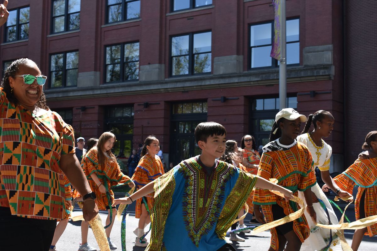 Students and faculty members from Grant Elementary dance their way east down Spokane Falls Boulevard on Saturday during the Junior Lilac Parade.  (Erik Etherton/The Spokesman-Review)