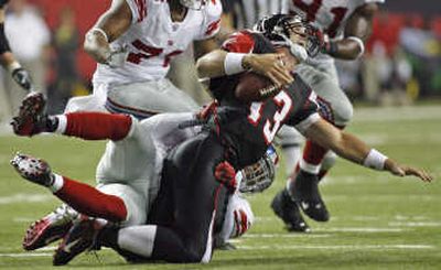 
It was a rough night for Falcons quarterback Joey Harrington, sacked in the second quarter here by Antonio Pierce. Associated Press
 (Associated Press / The Spokesman-Review)