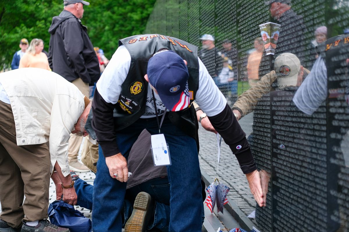 A Vietnam veteran touches the name of his fallen comrade at the Vietnam War Memorial in Washington, D.C., during the Inland Northwest Honor Flight visit on April 29, 2026. (Orion Donovan Smith/The Spokesman-Review)