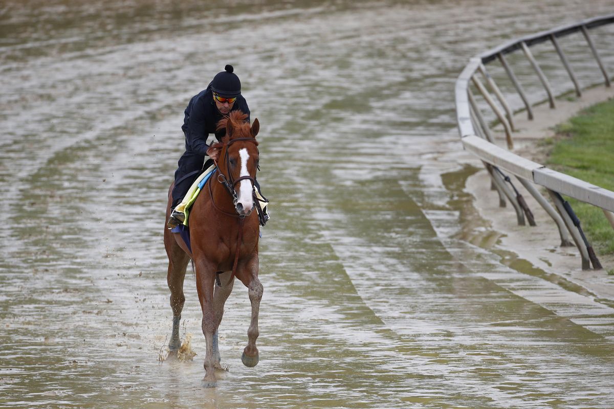 Kentucky Derby winner Justify, with exercise rider Humberto Gomez aboard, gallops around the track, Thursday, May 17, 2018, at Pimlico Race Course in Baltimore. The Preakness Stakes horse race is scheduled to take place Saturday, May 19. (Patrick Semansky / Associated Press)