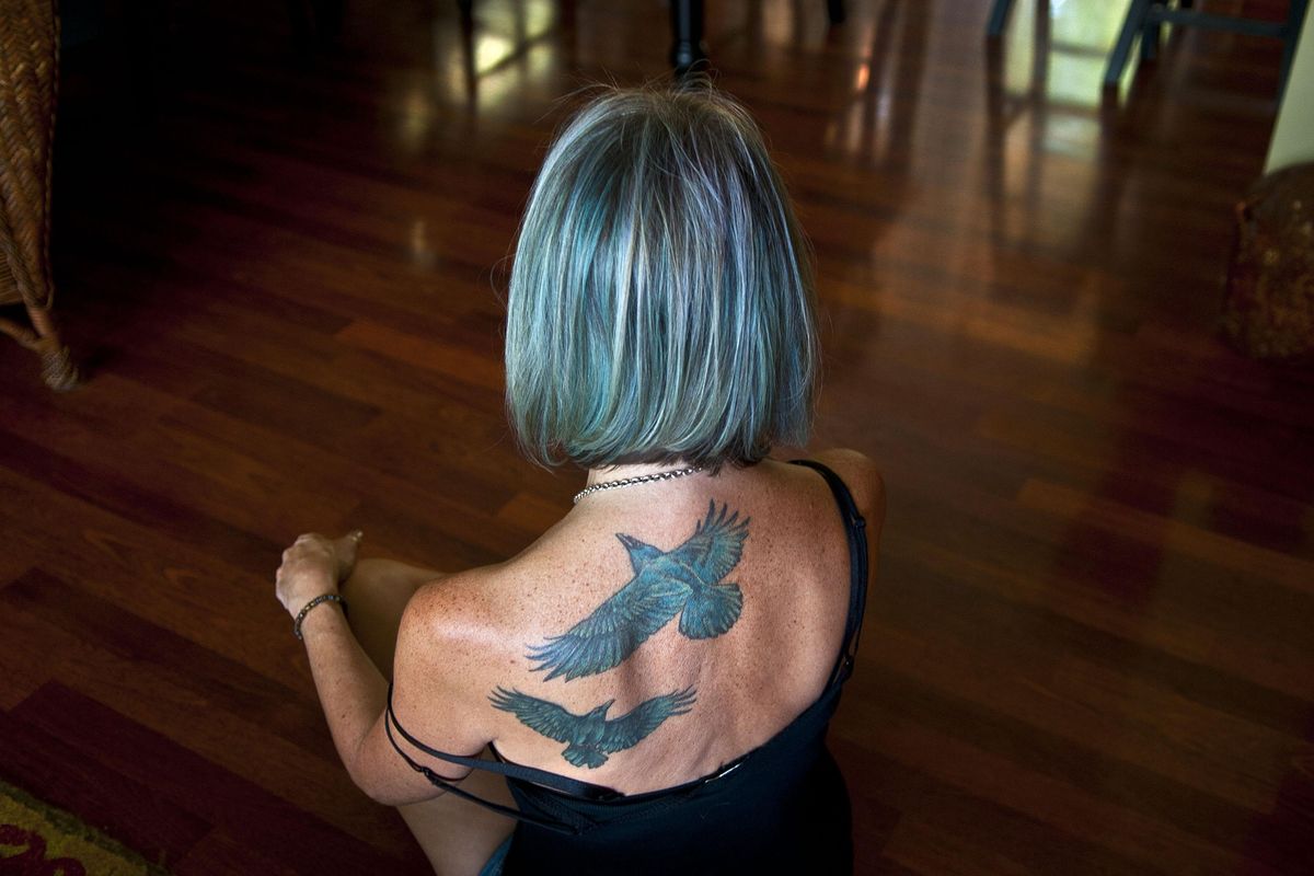 “I’m taking this journey with you,” said Lorri Stonehocker about getting two of her husband’s favorite birds tattooed on her back. Her husband passed away in March 2016. She is teaching a first-time class offered through Act 2 on Healthy Grieving. (Kathy Plonka / The Spokesman-Review)