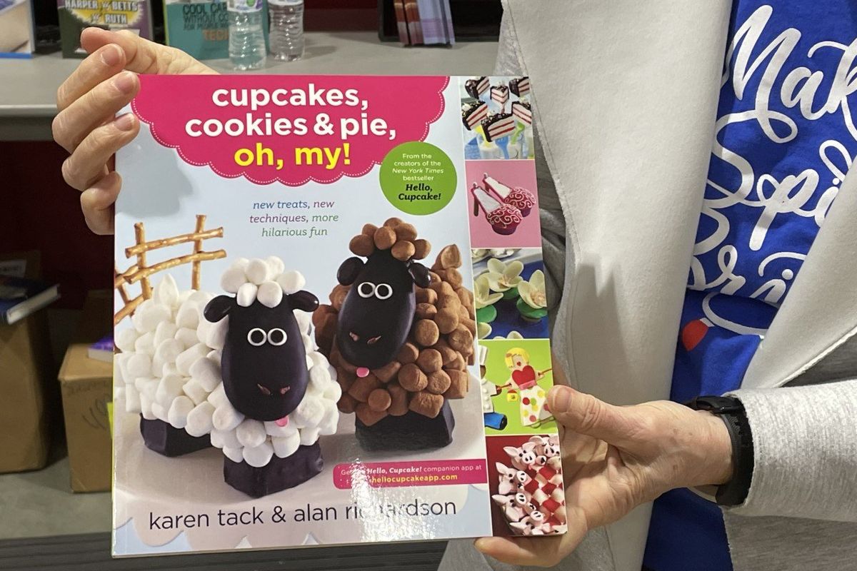 Volunteer Marguerite Michels shows off one of the popular books at the Christmas Bureau on Sunday, Dec. 12, 2021. (Nina Culver)