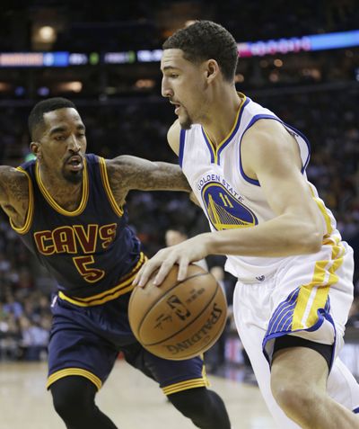 Golden State’s Klay Thompson, right, drives past Cleveland’s J.R. Smith in Warriors’ 113-89 win. (Associated Press)