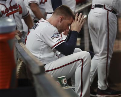 Atlanta Braves first baseman Freddie Freeman sits in the dugout during the ninth inning of the team’s 13-1 loss to the St. Louis Cardinals during Game 5 of a baseball National League Division Series on Wednesday, Oct. 9, 2019, in Atlanta. (Curtis Compton / Atlanta Journal-Constitution via AP)