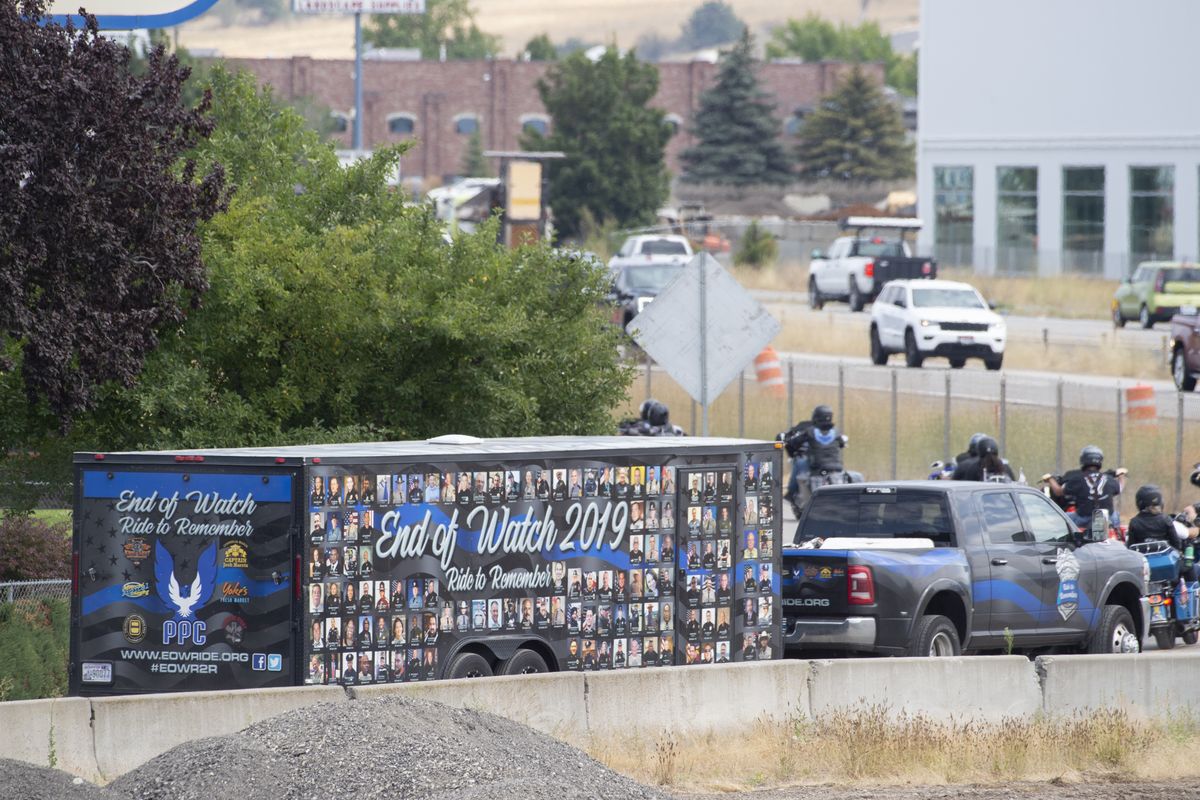 A trailer with the photos of police officers who died in the line of duty follows a group of motorcyclists participating in the End of Watch Ride to Remember event, Thursday, August 6, 2020. The group was arriving at Lone Wolf Harley Davidson in Spokane Valley.  (Jesse Tinsley/The Spokesman-Review)