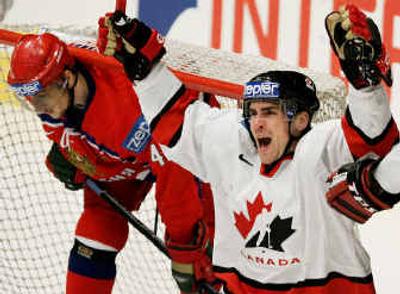 
Canada's Wade Redden, right, celebrates after he scored his team's first goal in Saturday's semifinal victory over Russia. 
 (Associated Press / The Spokesman-Review)