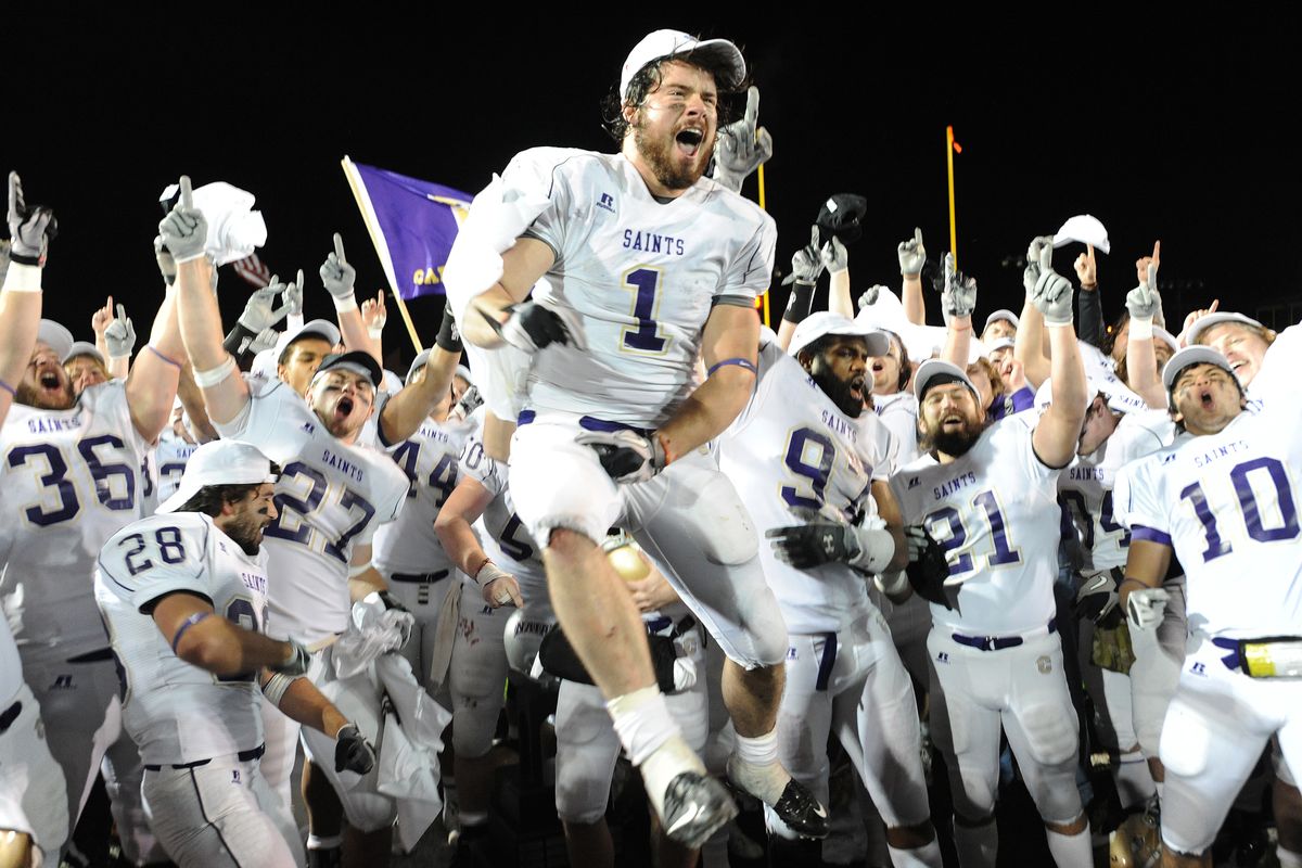 Saints RB John Camino (1) and other members of the team celebrate after beating Sioux Falls in the NAIA college football title game. (Associated Press)