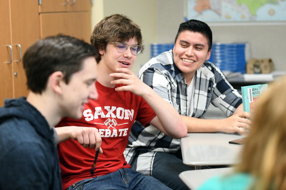 From left, Everett Lund, David Hoblitt and Hector Larios Mendoza hold a small group discussion about character development in their AP Literature class at Ferris High School Friday, April 13, 2018. Washington schools are moving from No Child Left Behind to a newer evaluation system. (Jesse Tinsley / The Spokesman-Review)