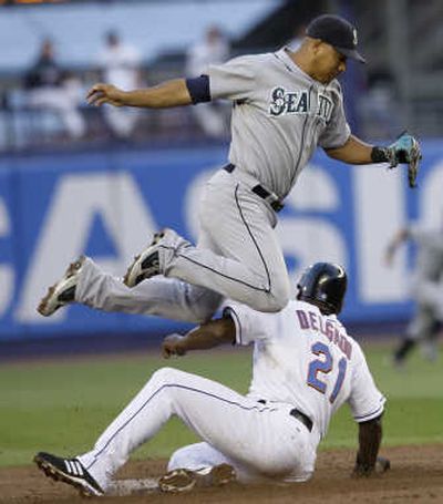 
New York's Carlos Delgado slides safely under Seattle's Jose Lopez on play at second base. Associated Press
 (Associated Press / The Spokesman-Review)