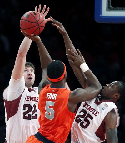 Syracuse's C.J. Fair tries to shoot over a double-team from Temple's Jake O'Brien, left, and Quenton DeCosey. (Associated Press)