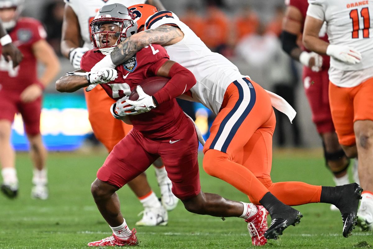 Syracuse defensive back Justin Barron brings down Washington State wide receiver Kyle Williams during the first half of Friday’s Holiday Bowl in San Diego.  (Tyler Tjomsland/The Spokesman-Review)